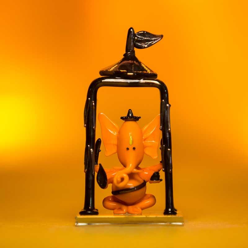 Bal Ganesh Orange Glass Idol in Temple